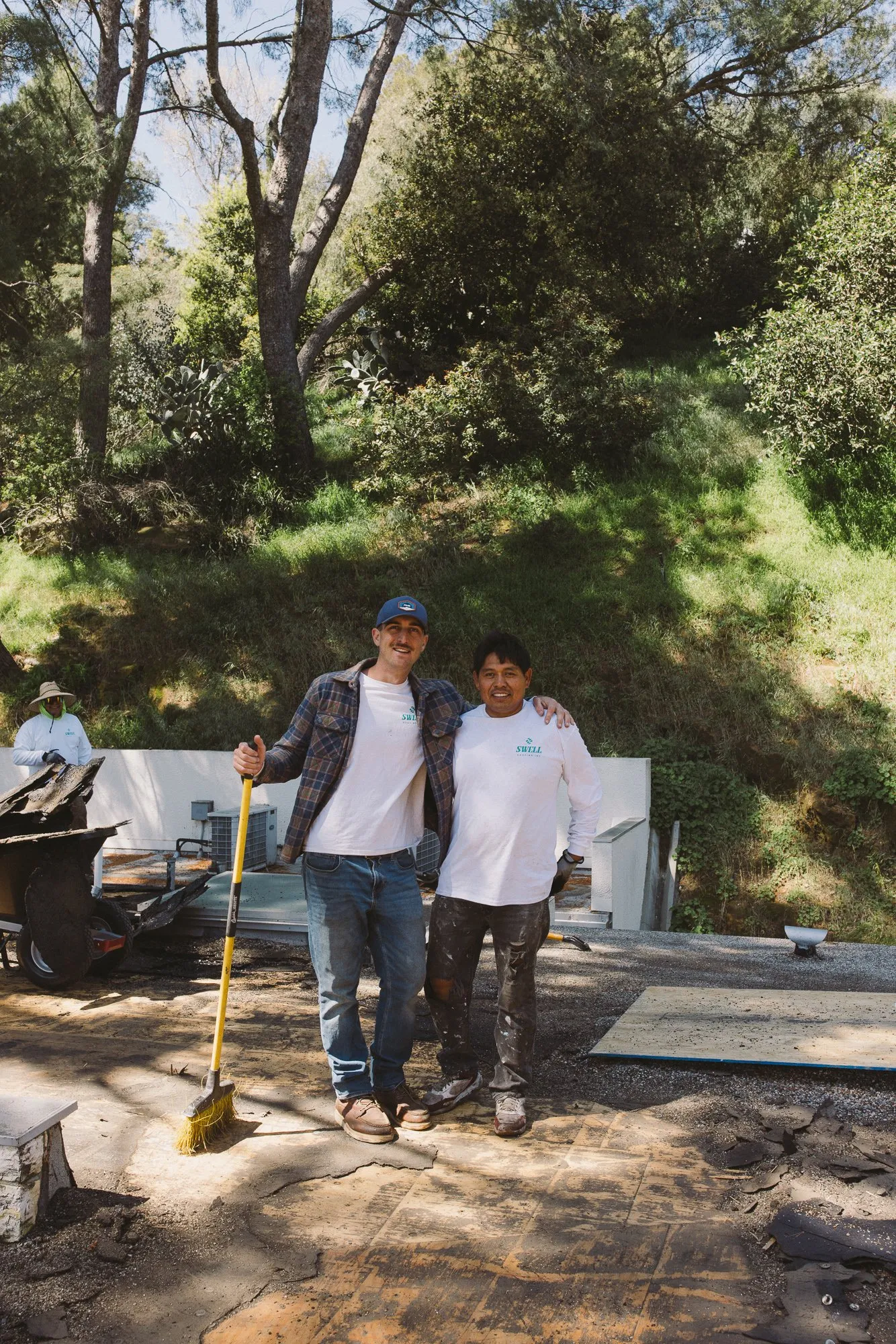 Asa Wolfe standing with a Swell Roofing crew member at a Southern California job site