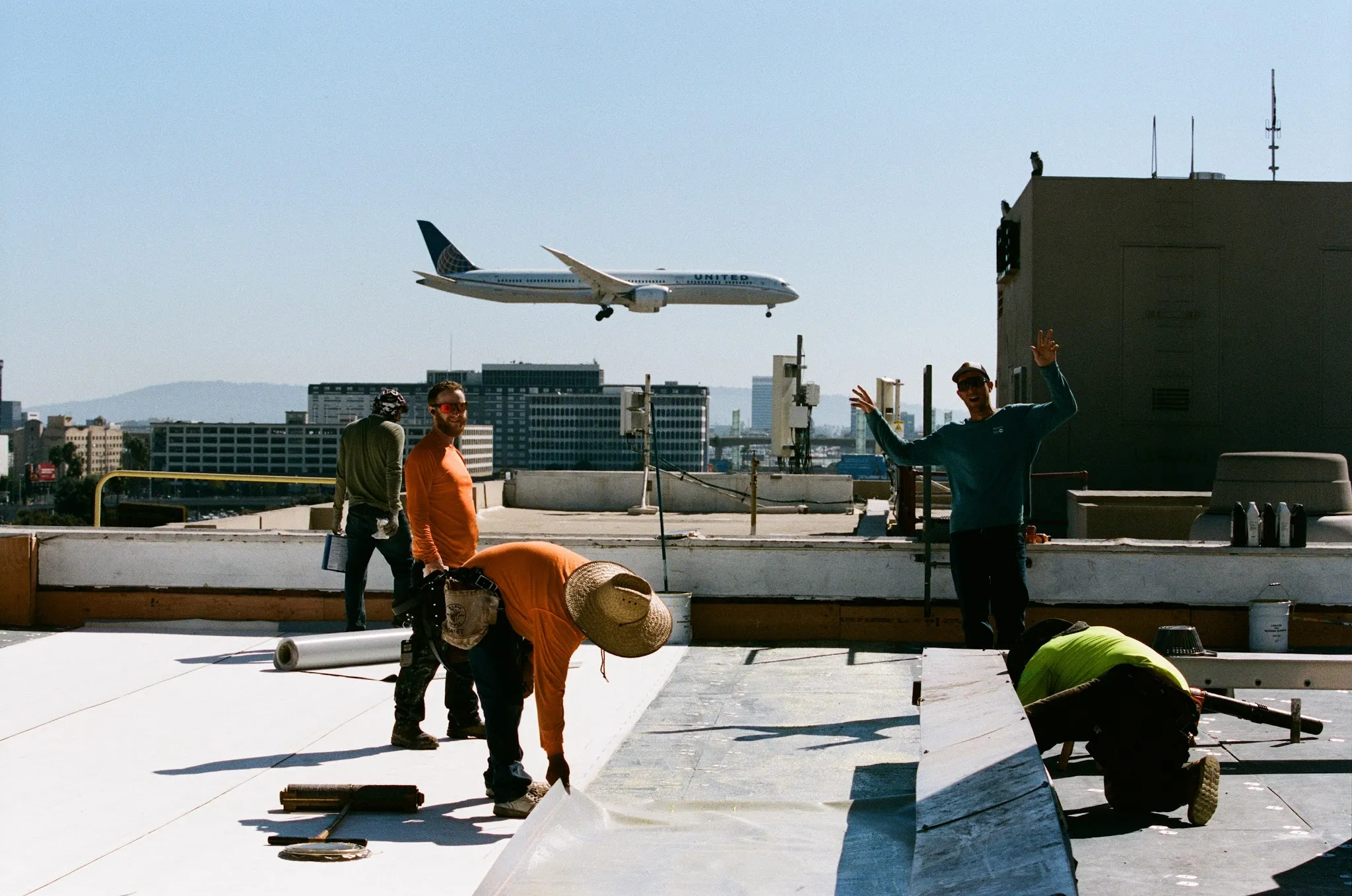 Swell Roofing crew working on a commercial flat roof near Los Angeles